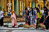 Yangon Myanmar. Shwedagon Pagoda (the Golden Stupa). Some fervent believers sweep some square meters of the pagoda, and symbolically washing their sins. 